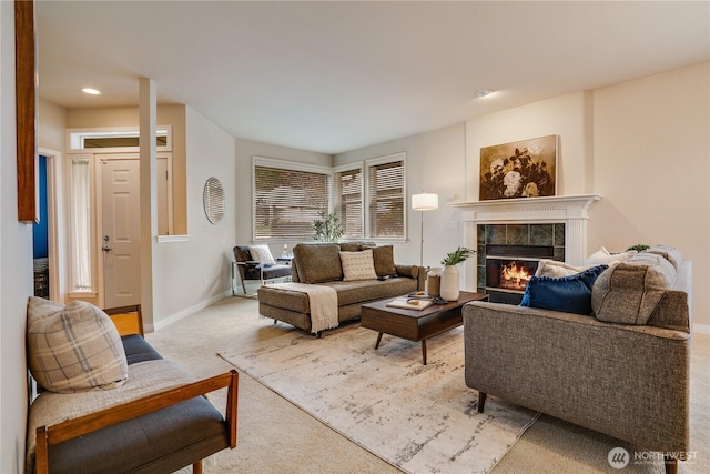 living area featuring recessed lighting, baseboards, light colored carpet, and a fireplace