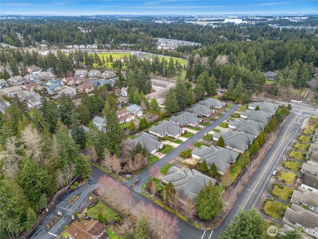 birds eye view of property featuring a forest view and a residential view