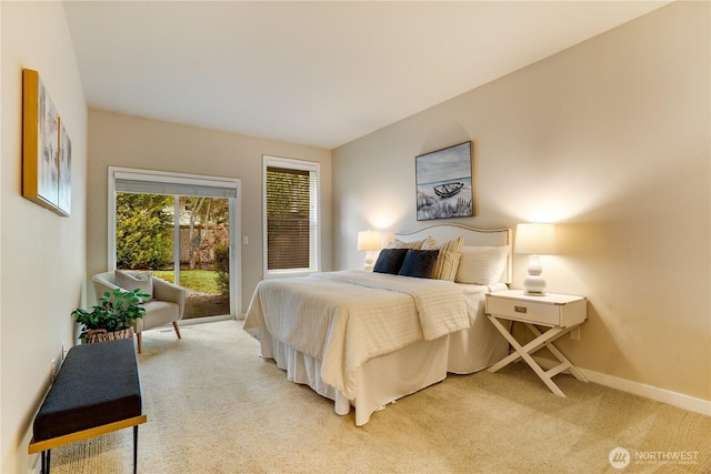 bedroom with light carpet, baseboards, and access to outside