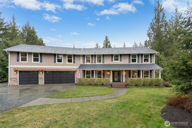 view of front facade featuring a garage, stone siding, aphalt driveway, covered porch, and a front yard