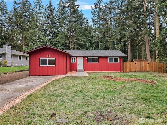 ranch-style house featuring fence, board and batten siding, and a front yard