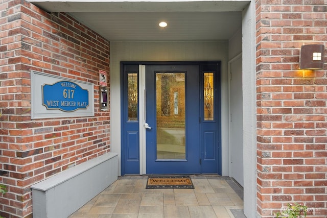 view of exterior entry with brick siding