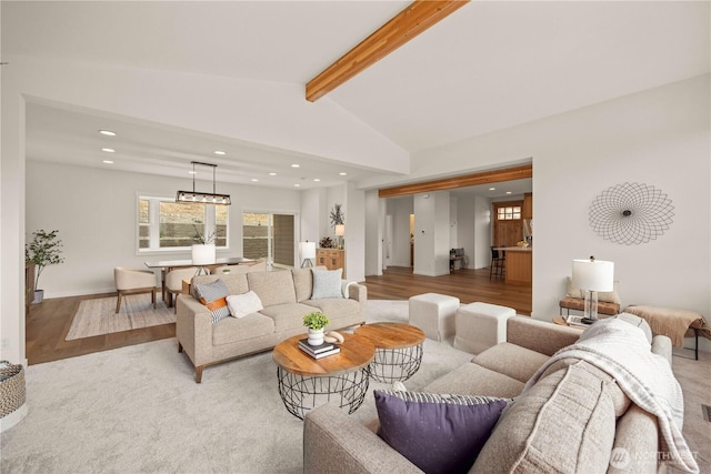 living area with recessed lighting, vaulted ceiling with beams, and wood finished floors