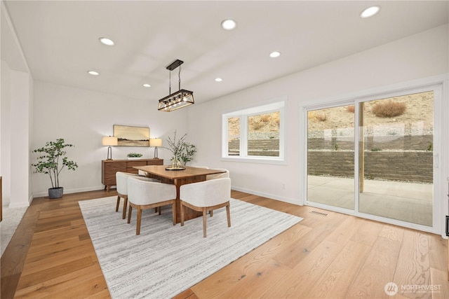 dining space with light wood-style floors, baseboards, and recessed lighting