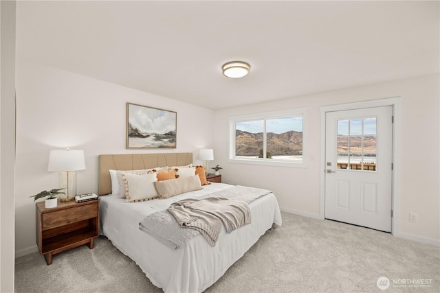 bedroom with light carpet and baseboards