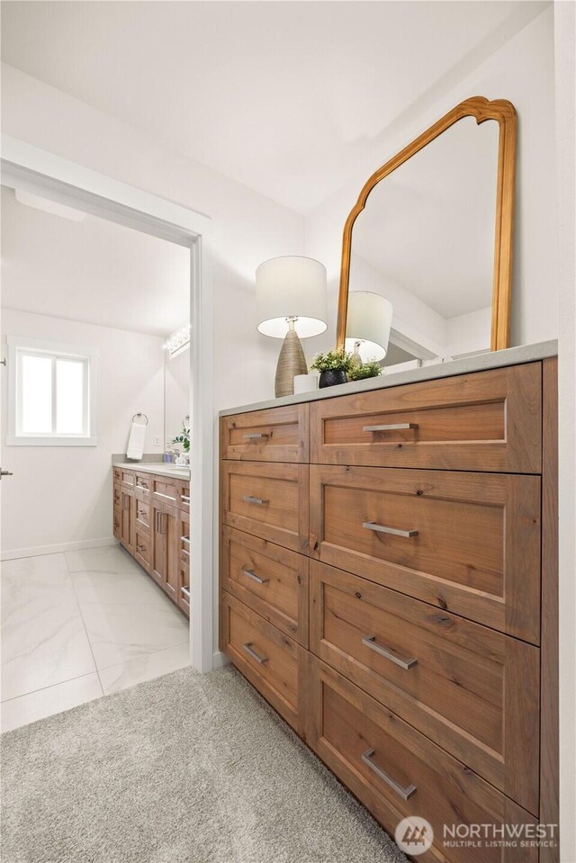 bathroom featuring marble finish floor, carpet, and vanity