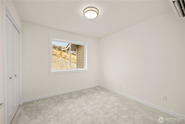 unfurnished bedroom featuring carpet, a closet, and baseboards