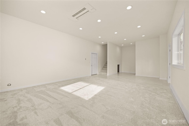 spare room with recessed lighting, light colored carpet, visible vents, stairway, and baseboards