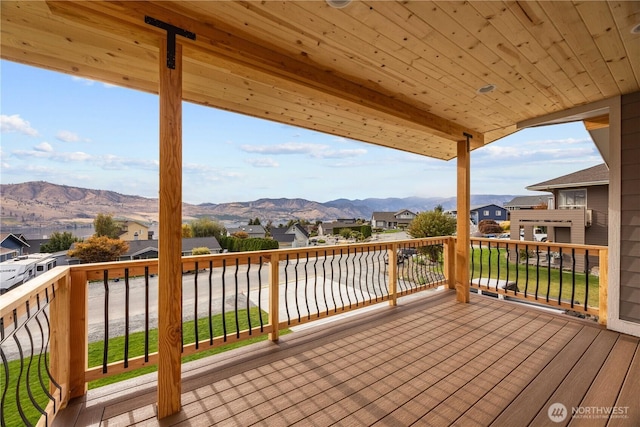 wooden deck featuring a residential view and a mountain view