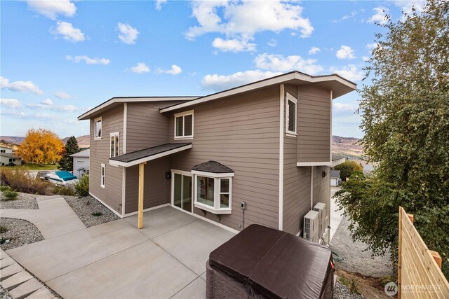 rear view of house with a patio area and fence