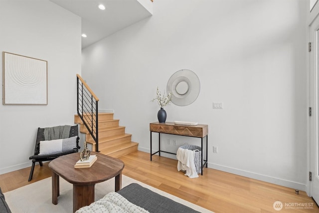 living area featuring recessed lighting, stairway, baseboards, and wood finished floors