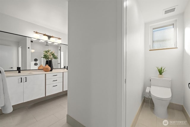 bathroom featuring tile patterned flooring, toilet, visible vents, vanity, and baseboards