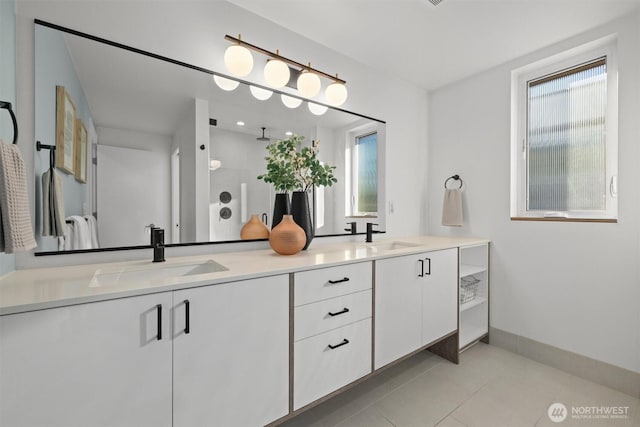 full bath featuring tile patterned floors, a sink, and double vanity