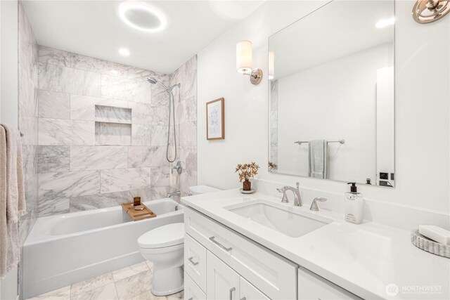 bathroom with toilet, marble finish floor, shower / washtub combination, and vanity