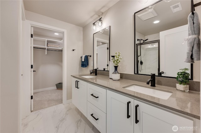 full bath with visible vents, marble finish floor, a stall shower, and a sink