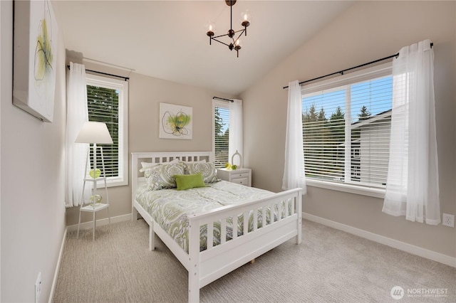 bedroom with baseboards, lofted ceiling, a notable chandelier, and carpet flooring