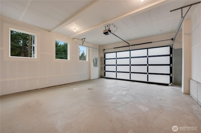 garage featuring electric panel and a garage door opener