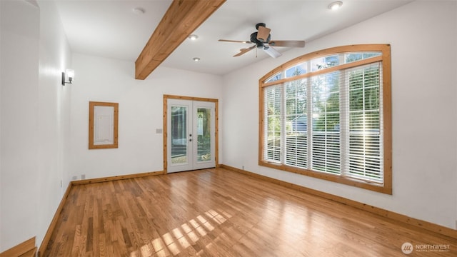 spare room featuring french doors, a ceiling fan, wood finished floors, beamed ceiling, and baseboards