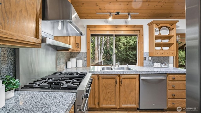 kitchen featuring appliances with stainless steel finishes, a sink, under cabinet range hood, open shelves, and backsplash