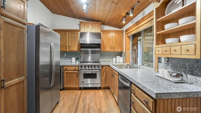 kitchen with lofted ceiling, brown cabinets, stainless steel appliances, and exhaust hood