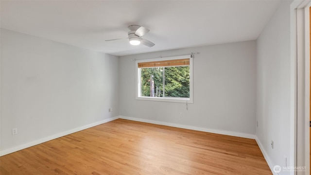 unfurnished room with ceiling fan, light wood-style flooring, and baseboards