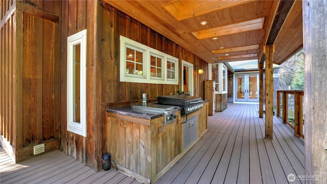 wooden terrace featuring exterior kitchen, french doors, a grill, and visible vents