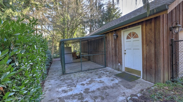 exterior space with roof with shingles