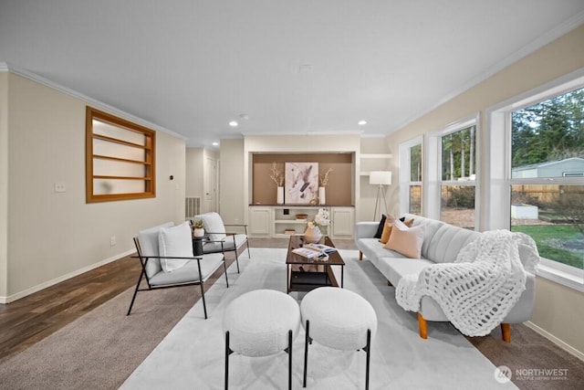 living area with ornamental molding, recessed lighting, visible vents, and baseboards