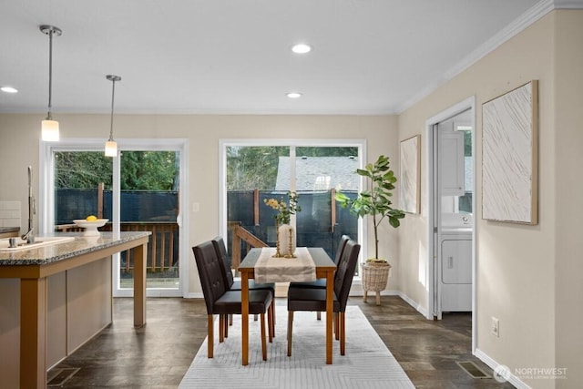 dining room featuring recessed lighting, dark wood-type flooring, baseboards, washer / clothes dryer, and crown molding