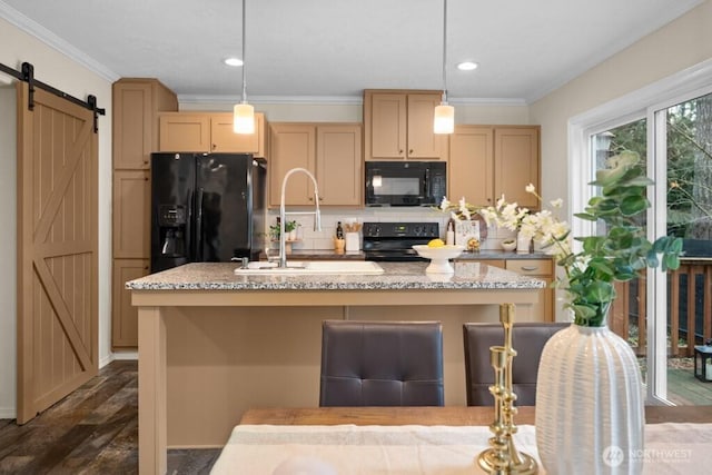 kitchen featuring decorative backsplash, a barn door, ornamental molding, a sink, and black appliances