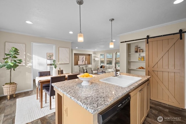 kitchen with black dishwasher, a center island with sink, a barn door, ornamental molding, and a sink