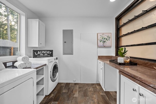 washroom featuring dark wood-style floors, cabinet space, washing machine and dryer, and electric panel