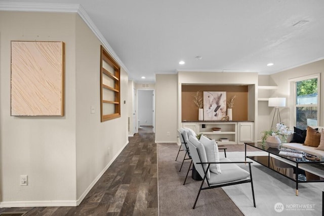 living area featuring crown molding, wood finished floors, and baseboards