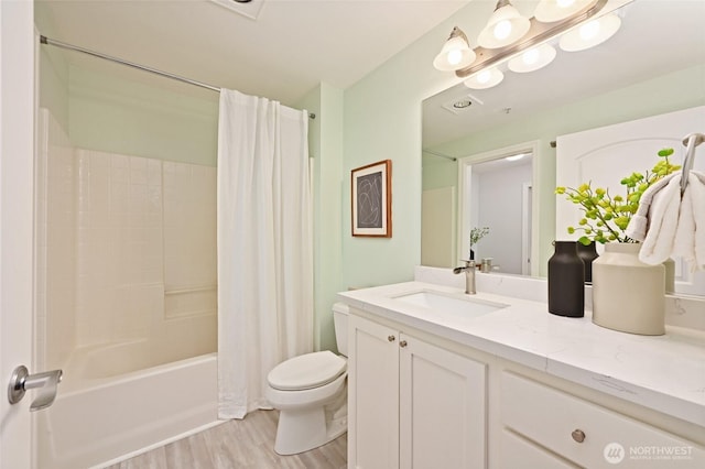 full bathroom with vanity, toilet, wood finished floors, and shower / tub combo