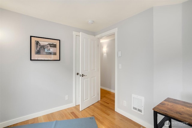 interior space with light wood-type flooring, baseboards, and visible vents