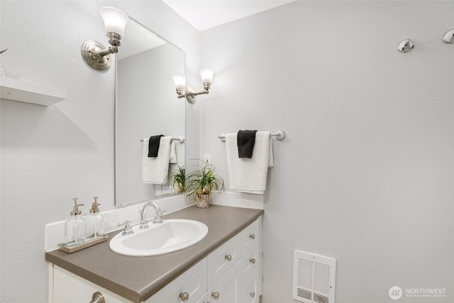 bathroom with vanity and visible vents