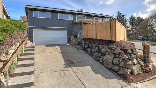 view of front of property with brick siding, driveway, and a garage