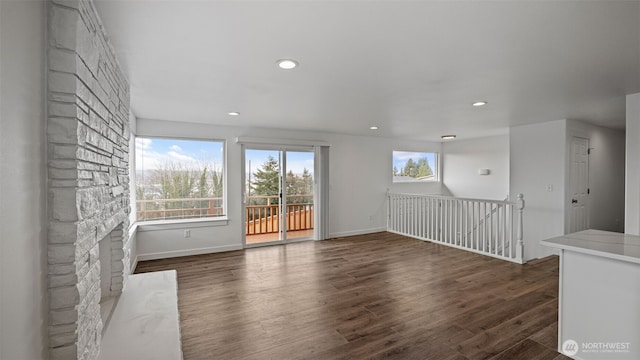 unfurnished room featuring recessed lighting, wood finished floors, and baseboards