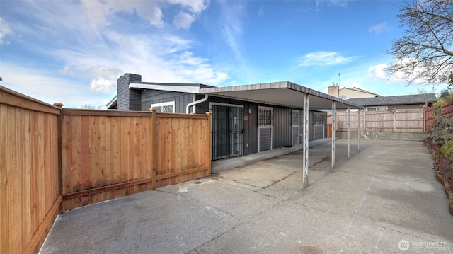 exterior space with fence private yard, a chimney, and a patio area