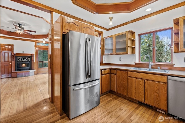 kitchen with brown cabinets, appliances with stainless steel finishes, open shelves, and a sink