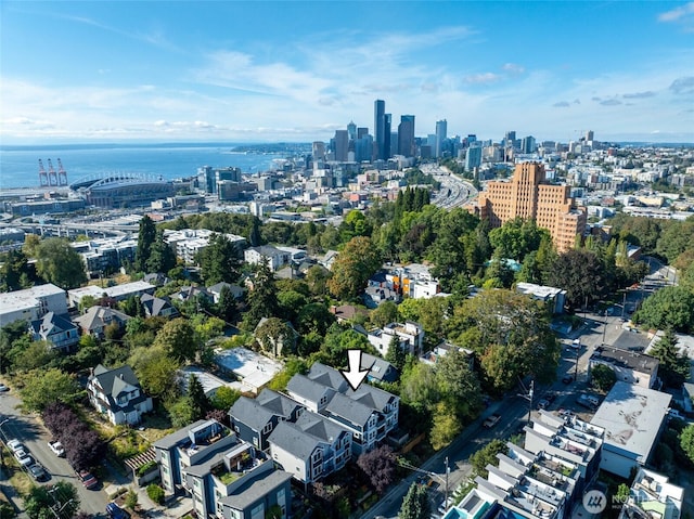 birds eye view of property with a view of city and a water view