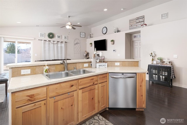 kitchen with dark wood-style floors, light countertops, stainless steel dishwasher, vaulted ceiling, and a sink