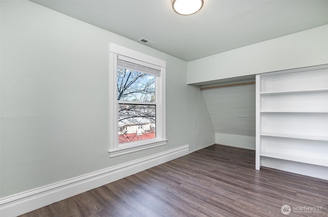 interior space featuring wood finished floors, visible vents, and a closet