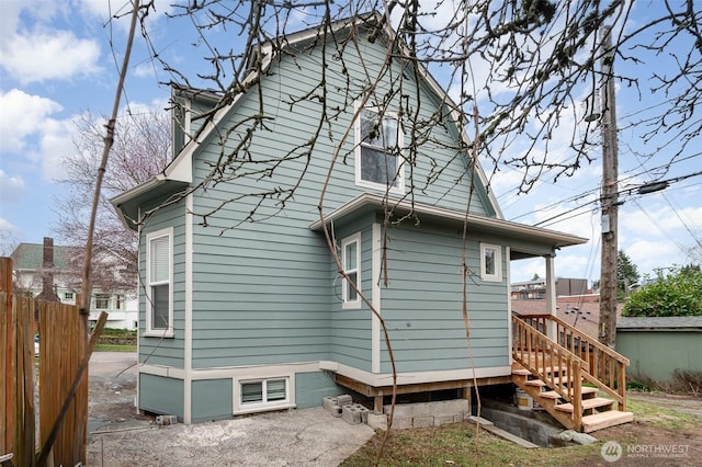 back of house featuring fence