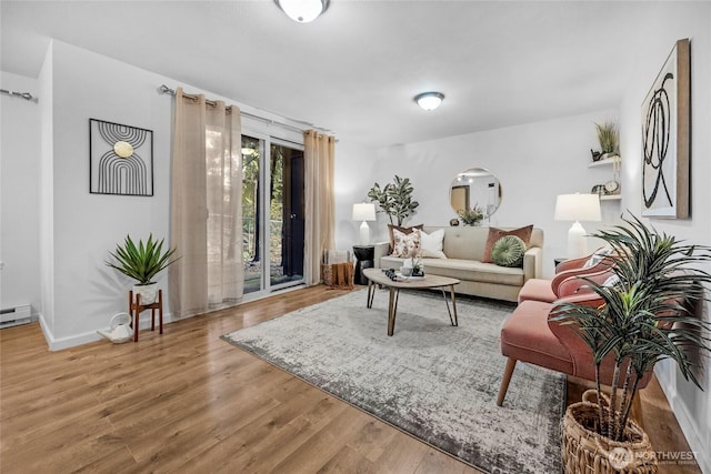 living room featuring wood finished floors, arched walkways, and baseboards