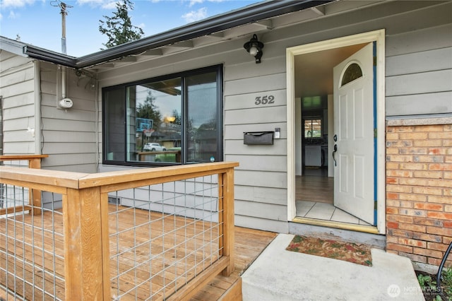 doorway to property with brick siding