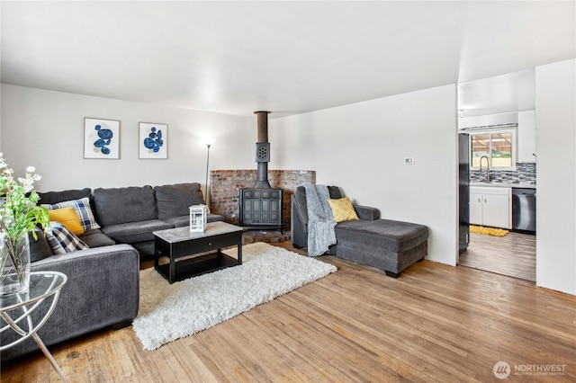 living area featuring a wood stove and wood finished floors