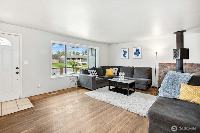 living room featuring a wood stove and wood finished floors