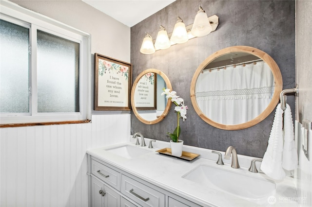 full bath with double vanity and a sink