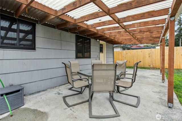 view of patio / terrace with outdoor dining space, fence, and a pergola